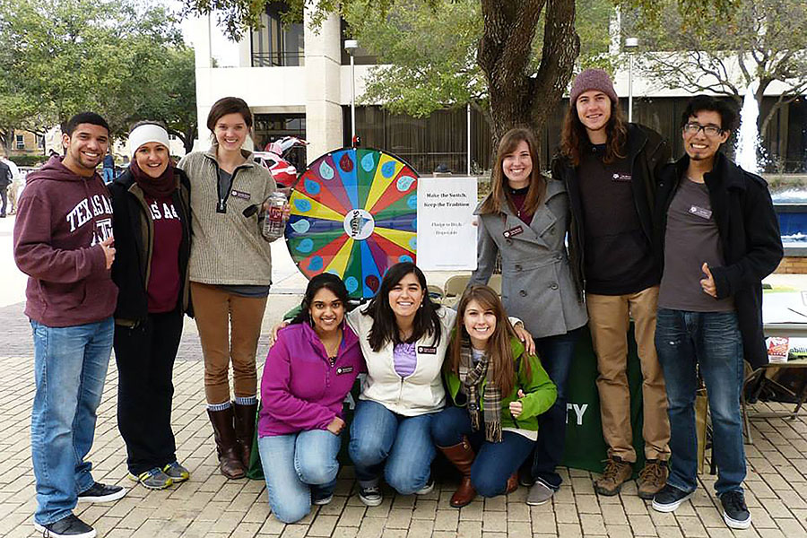 Student interns and staff pose at a tabling event in the Spring of 2014.