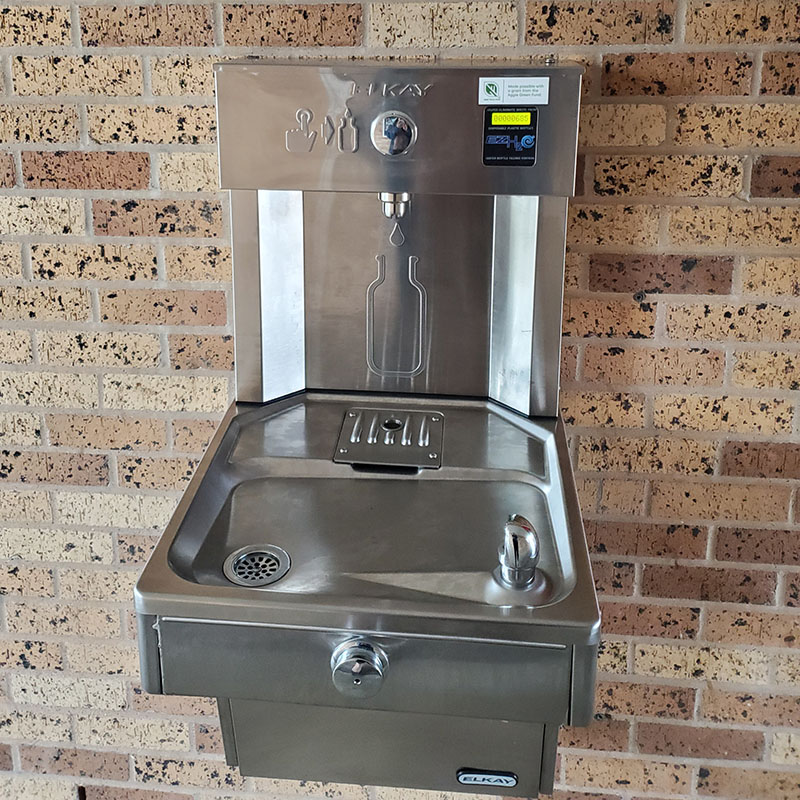 An outdoor hydration or water-bottle filling station.