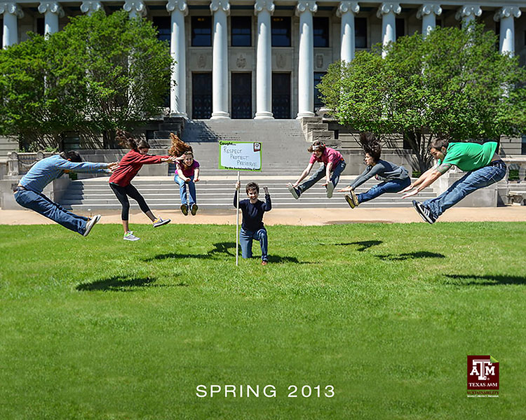 The student interns jumping on the grounds of the J.K. Williams Administration Building.